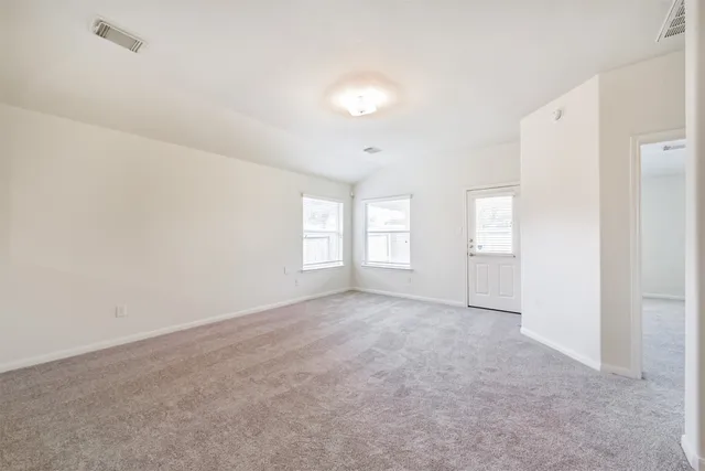 an empty room with windows and closet