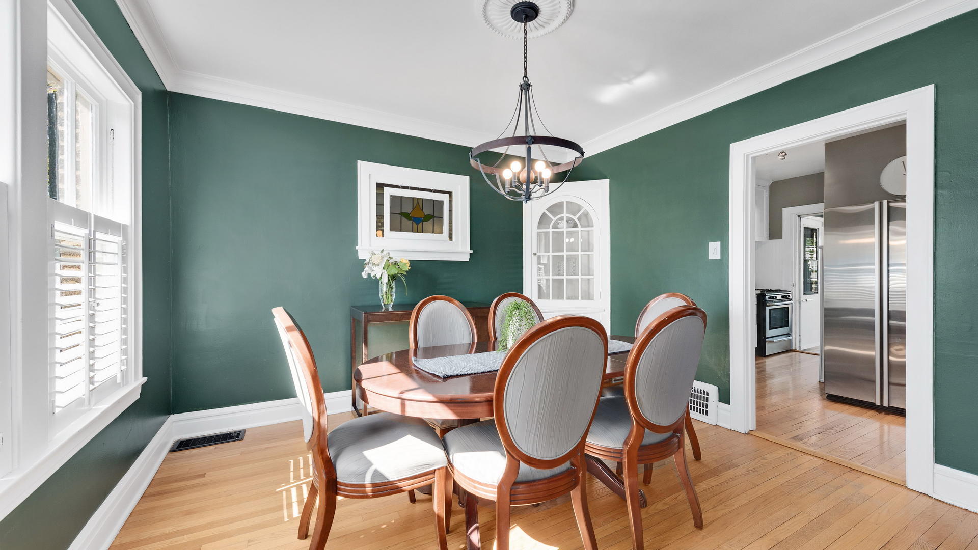 3929 Wolf Road Western Springs, IL 60558 - Photo 7 of 26 a dining room with furniture a chandelier and wooden floor