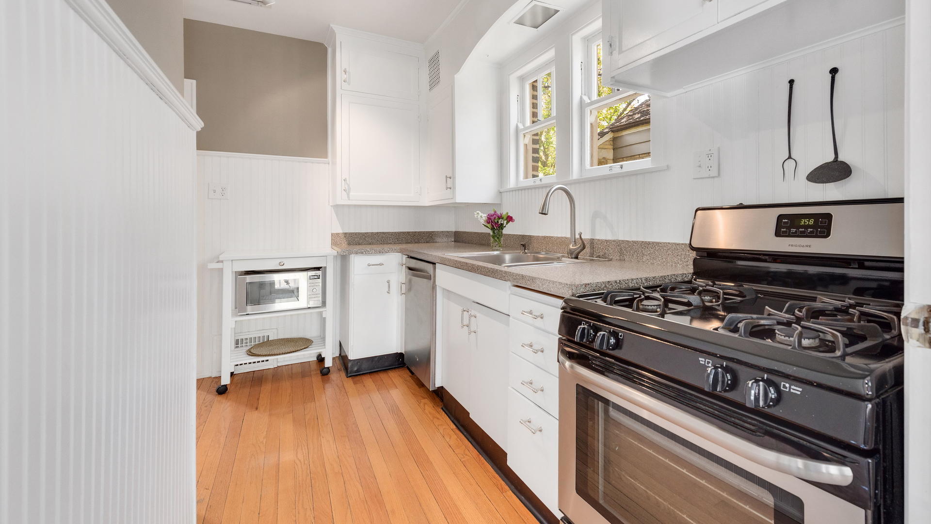 3929 Wolf Road Western Springs, IL 60558 - Photo 9 of 26 a kitchen with a stove a sink and a microwave