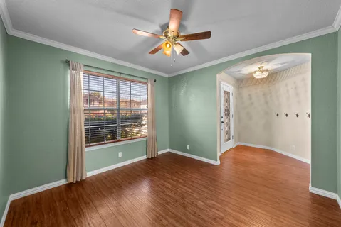wooden floor in an empty room with a window
