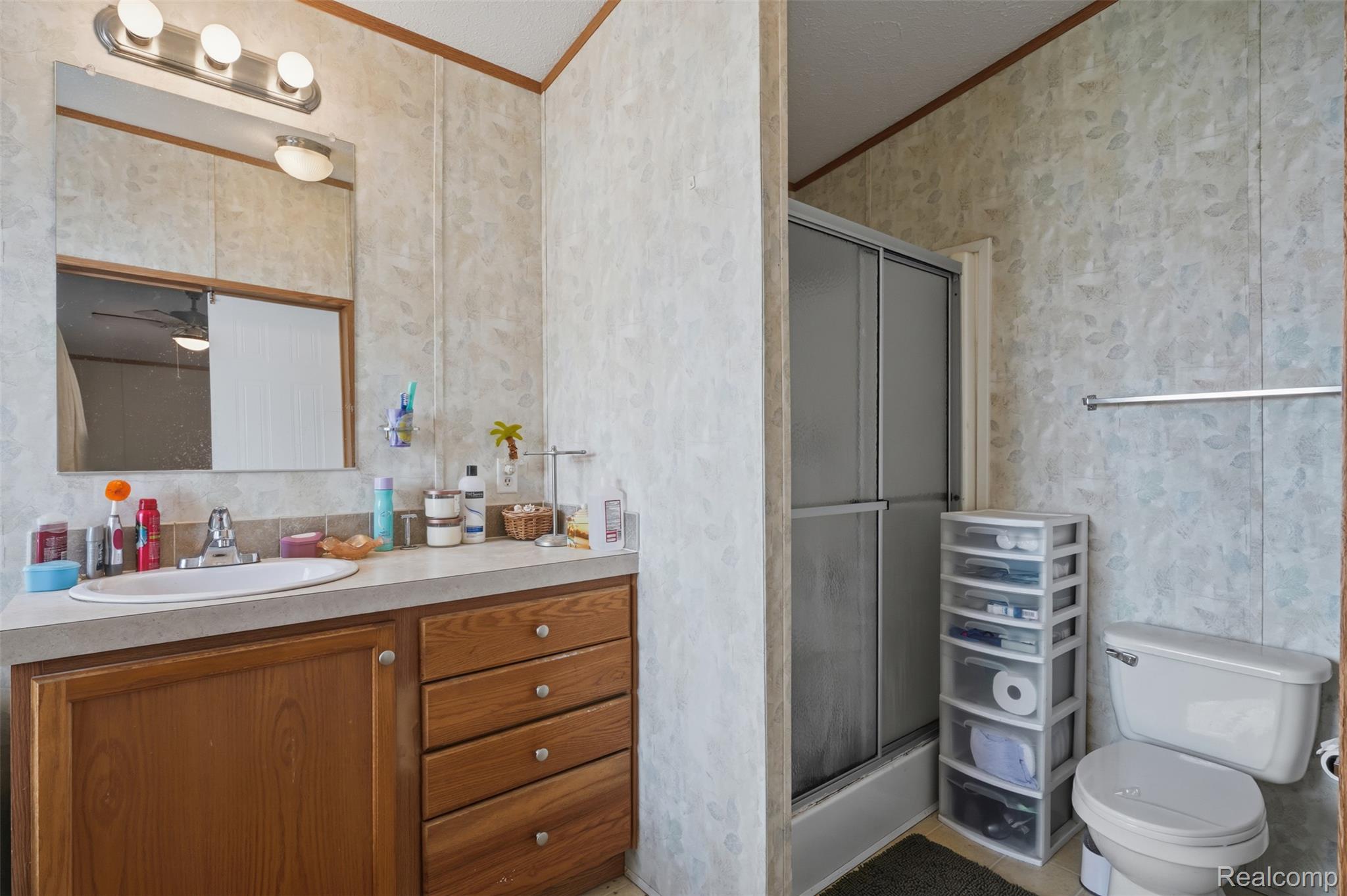 29643 Carousel Street Novi, MI 48377 - Photo 10 of 16 Wood-finish vanity with an integrated sink and chrome faucet
