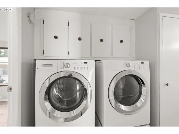 a view of a hallway with washer and dryer