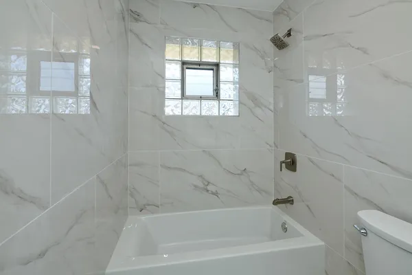 a white bath tub sitting next to a white sink