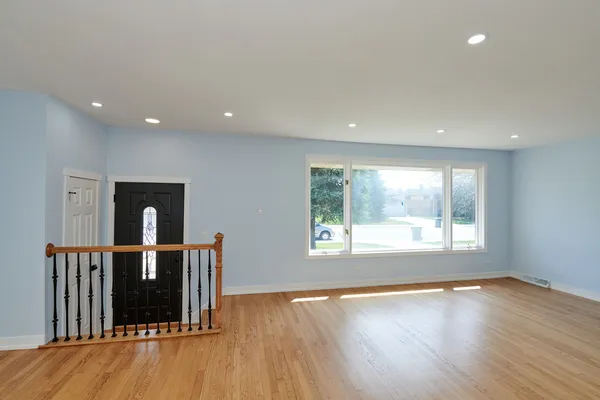 a view of a living room a window and wooden floor