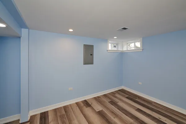 a view of a room with wooden floor and windows