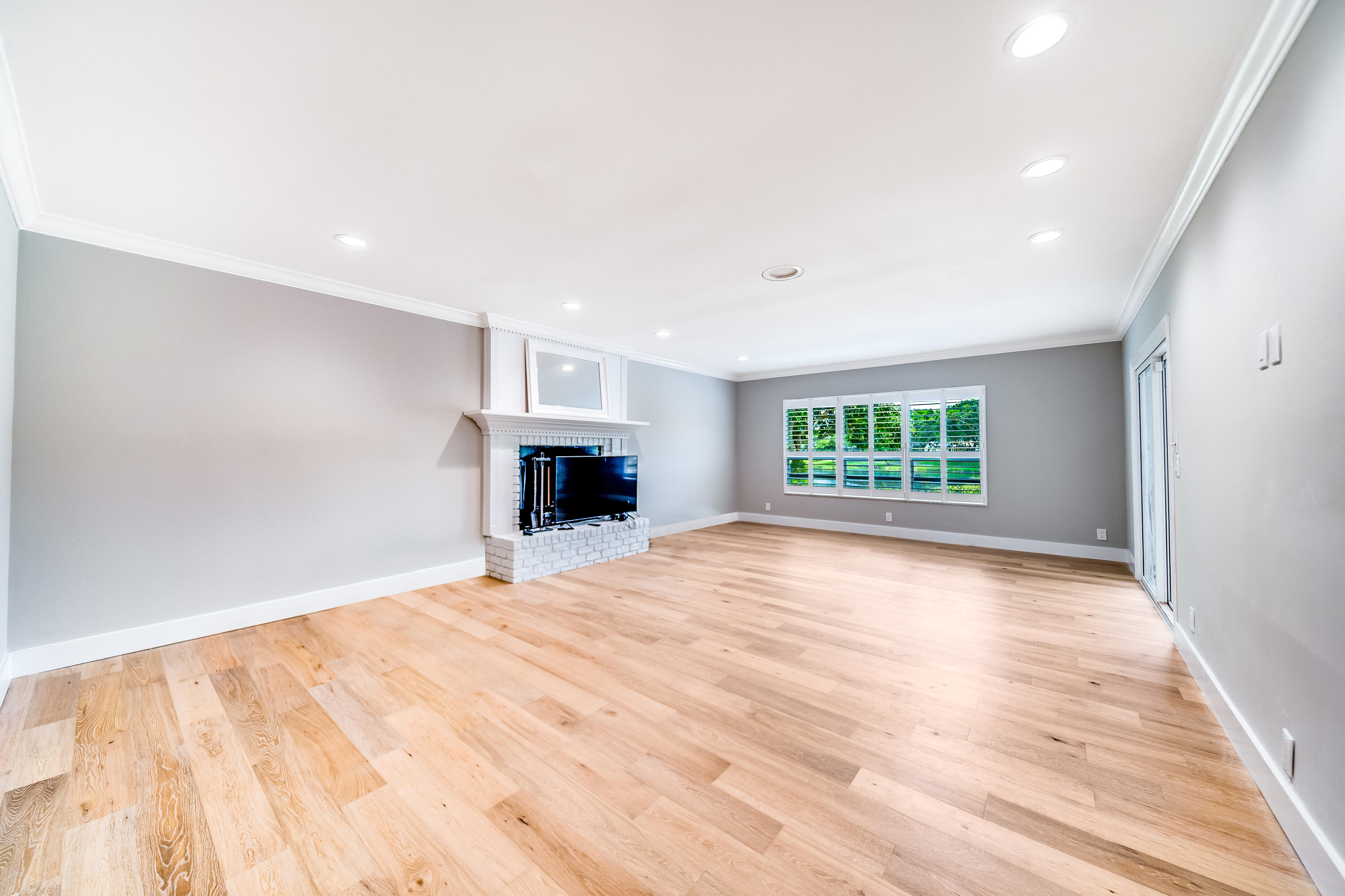 3402 Pine Haven Circle Boca Raton, FL 33431 - Photo 11 of 29 a view of empty room with wooden floor and fireplace