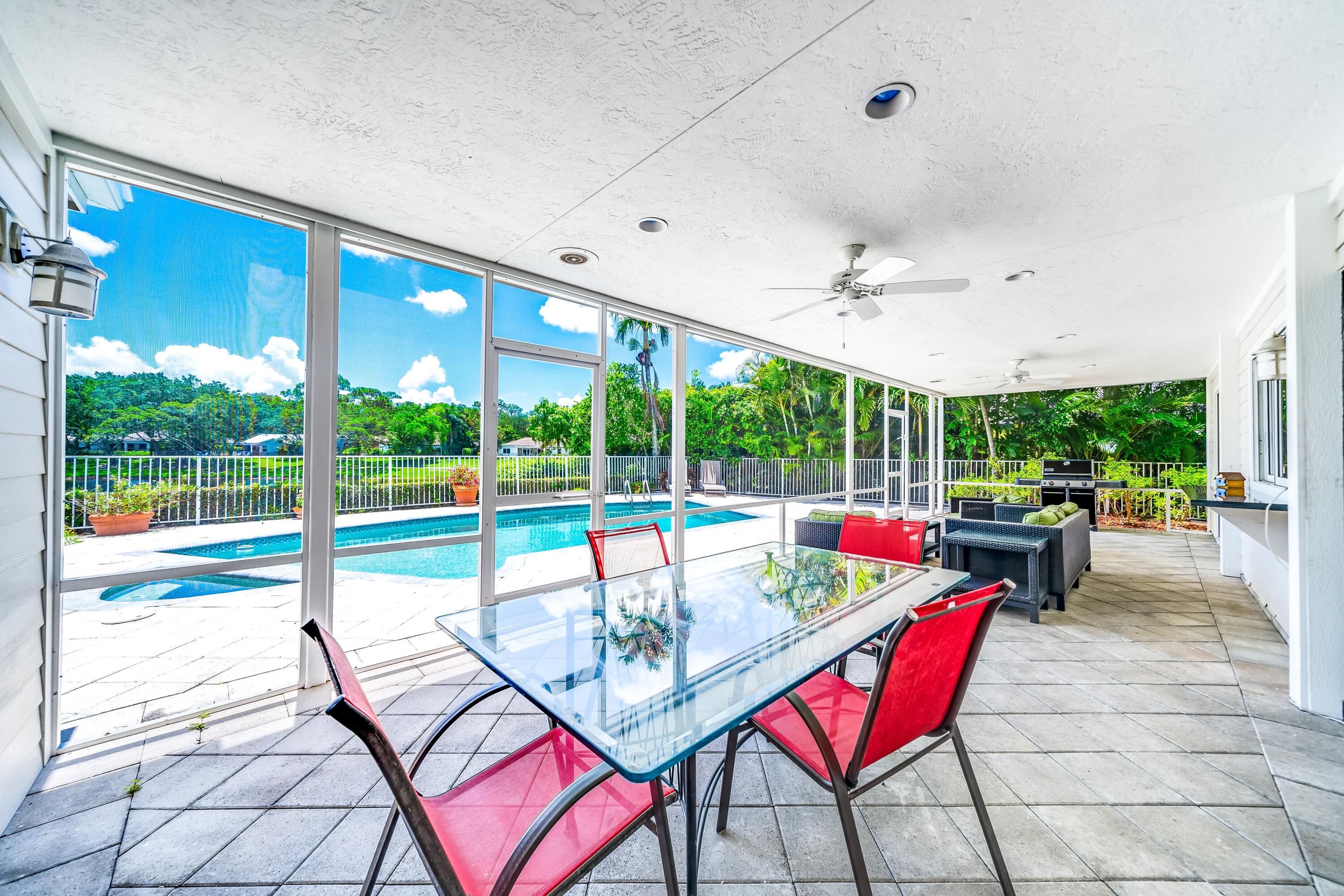 3402 Pine Haven Circle Boca Raton, FL 33431 - Photo 12 of 29 a living room with patio furniture and a floor to ceiling window