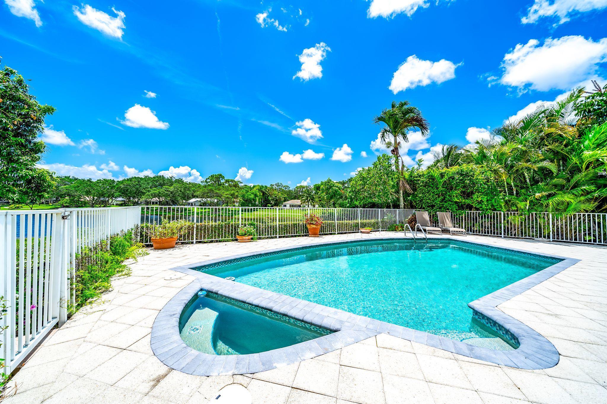 3402 Pine Haven Circle Boca Raton, FL 33431 - Photo 14 of 29 a view of a swimming pool with a lounge chairs
