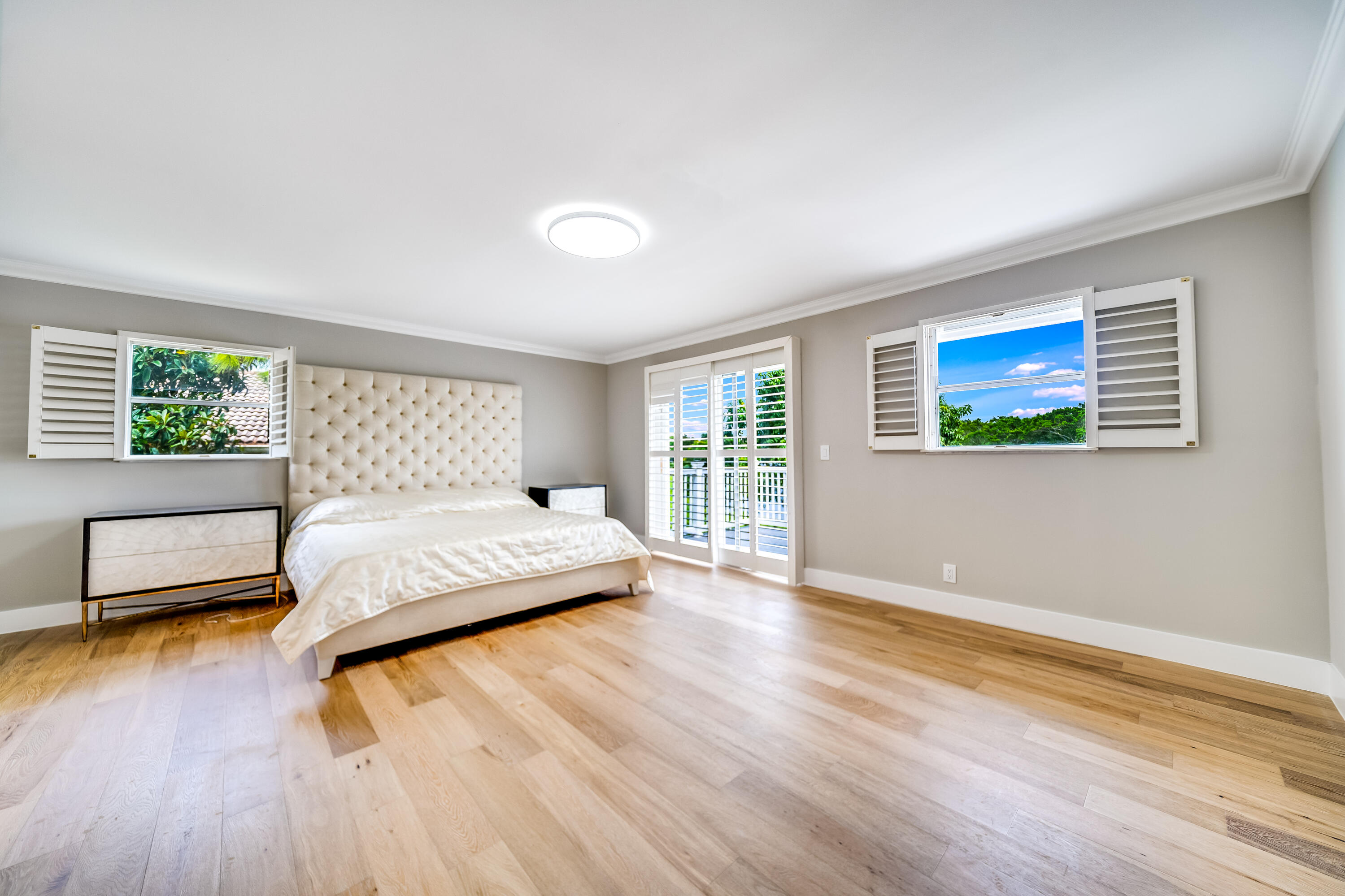 3402 Pine Haven Circle Boca Raton, FL 33431 - Photo 17 of 29 a bedroom with a bed and wooden floor