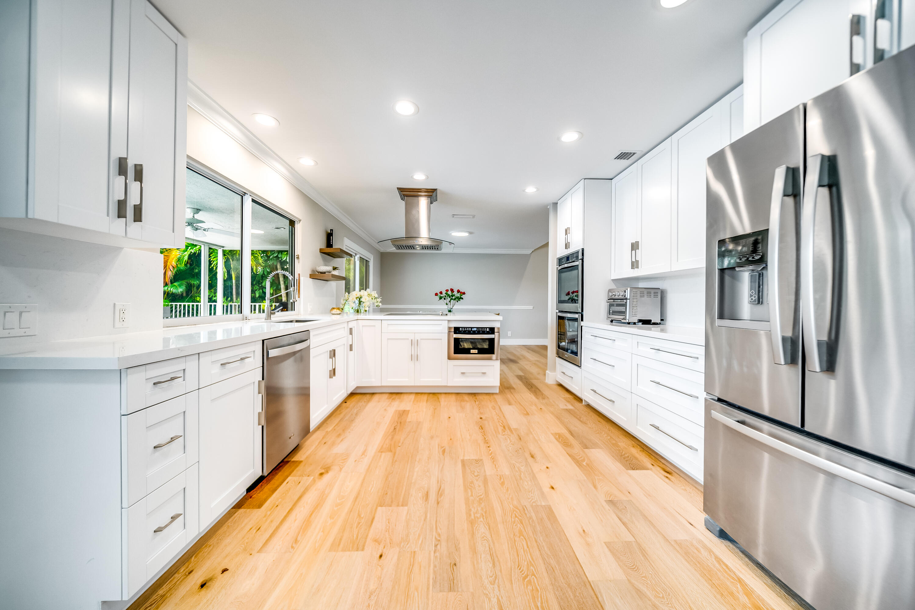 3402 Pine Haven Circle Boca Raton, FL 33431 - Photo 2 of 29 a large kitchen with stainless steel appliances a large counter top a stove a sink and a refrigerator