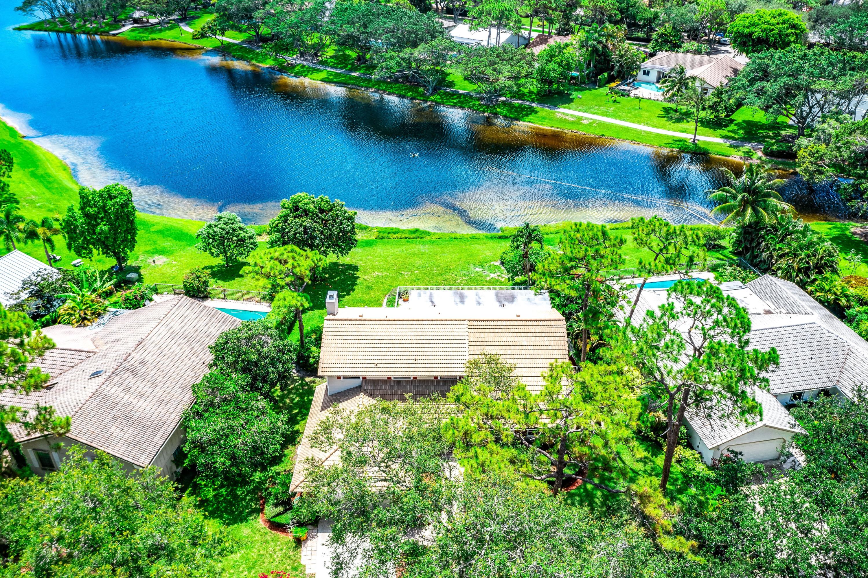 3402 Pine Haven Circle Boca Raton, FL 33431 - Photo 25 of 29 an aerial view of a house with a yard and lake view
