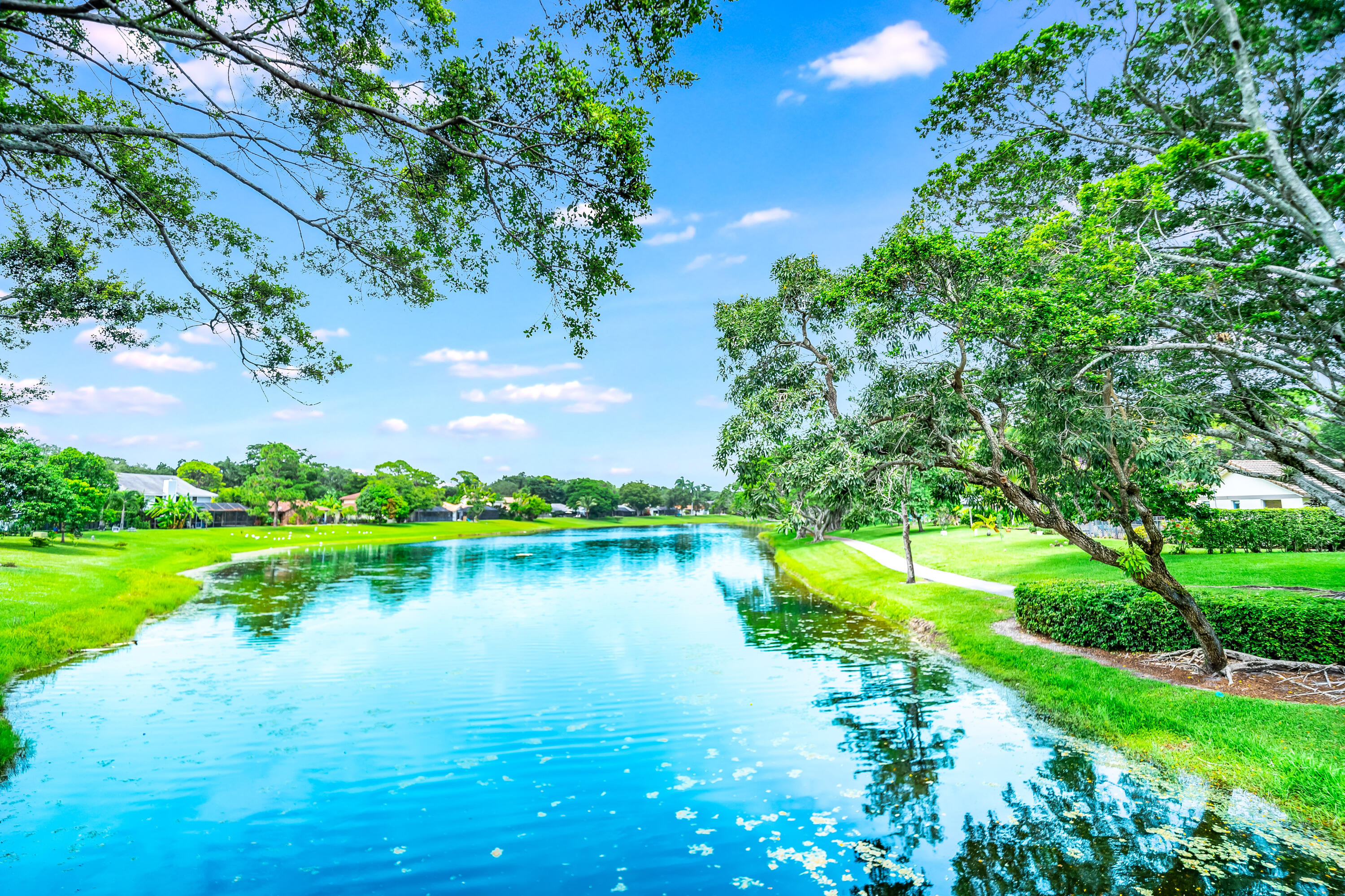 3402 Pine Haven Circle Boca Raton, FL 33431 - Photo 26 of 29 a view of a lake with houses in the back
