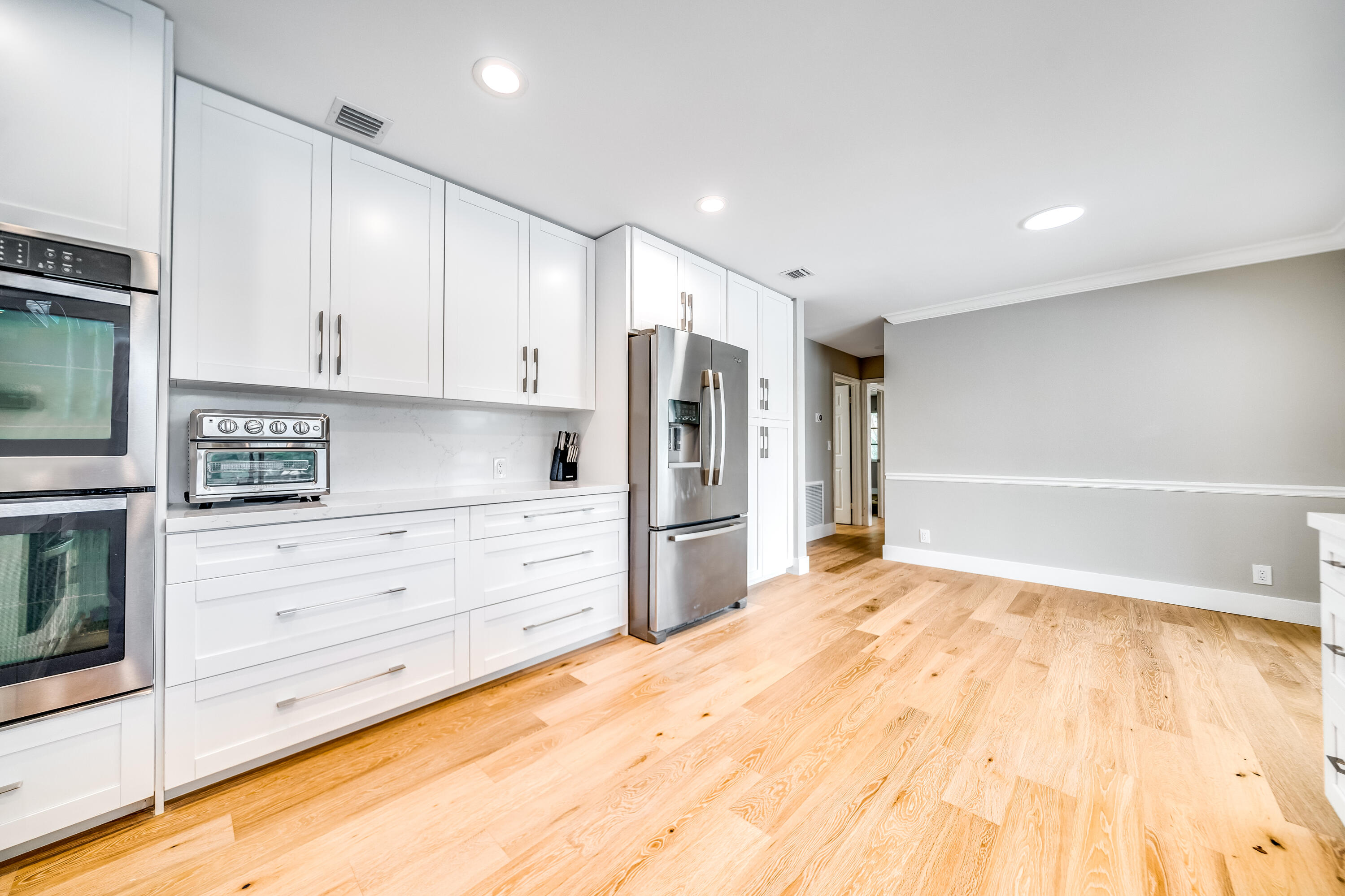 3402 Pine Haven Circle Boca Raton, FL 33431 - Photo 3 of 29 a kitchen with granite countertop white cabinets and stainless steel appliances