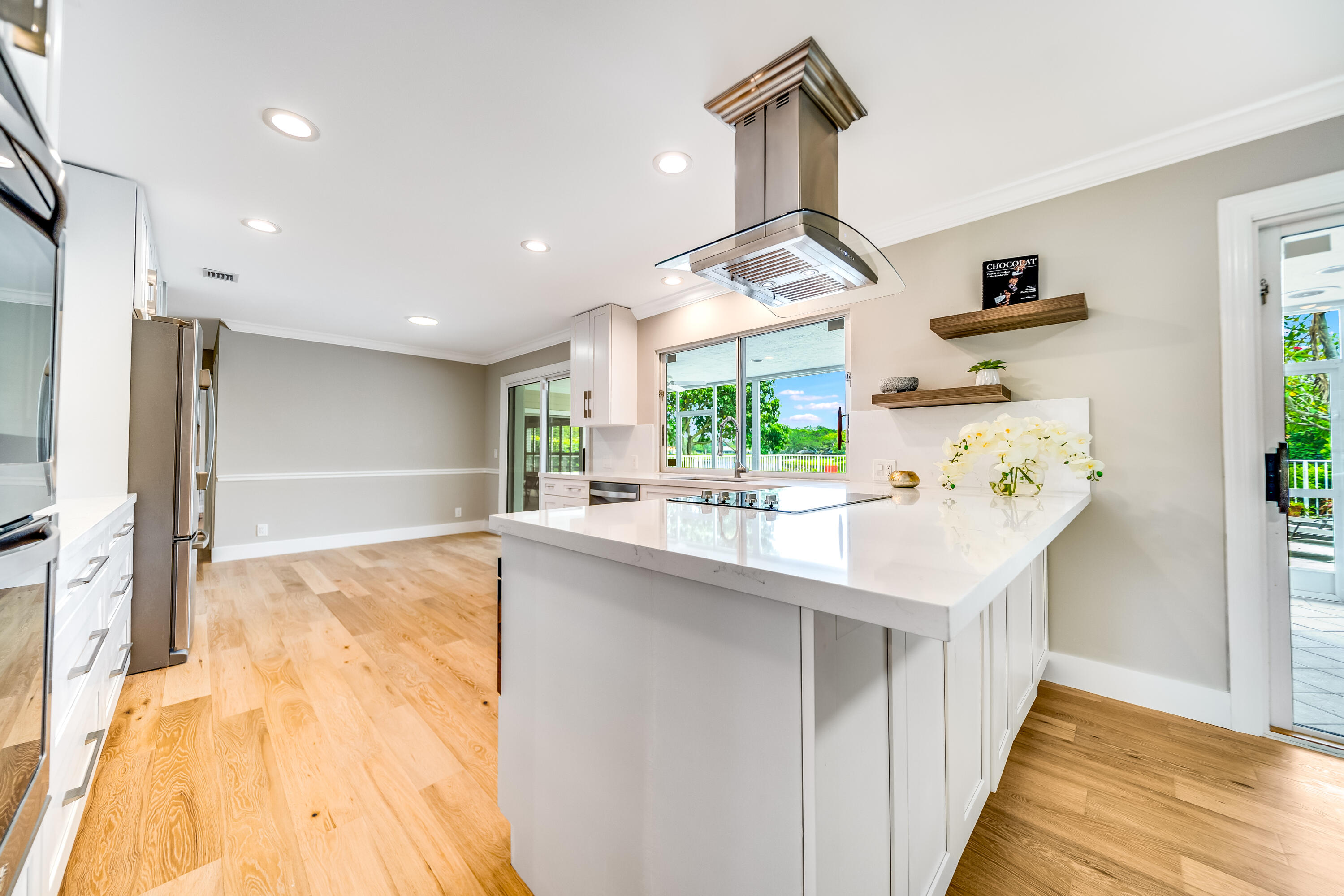 3402 Pine Haven Circle Boca Raton, FL 33431 - Photo 6 of 29 a kitchen with kitchen island a sink appliances and a counter top space