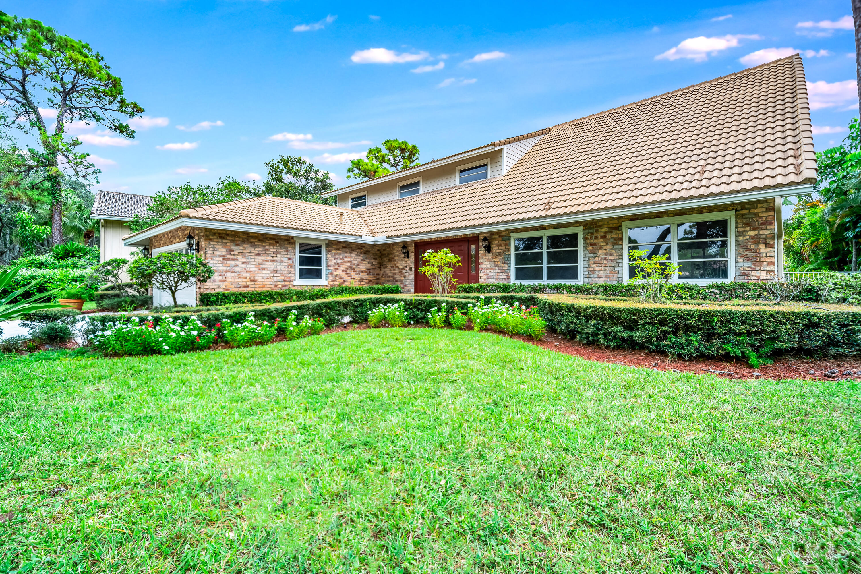3402 Pine Haven Circle Boca Raton, FL 33431 - Photo 8 of 29 a front view of a house with plants and garden