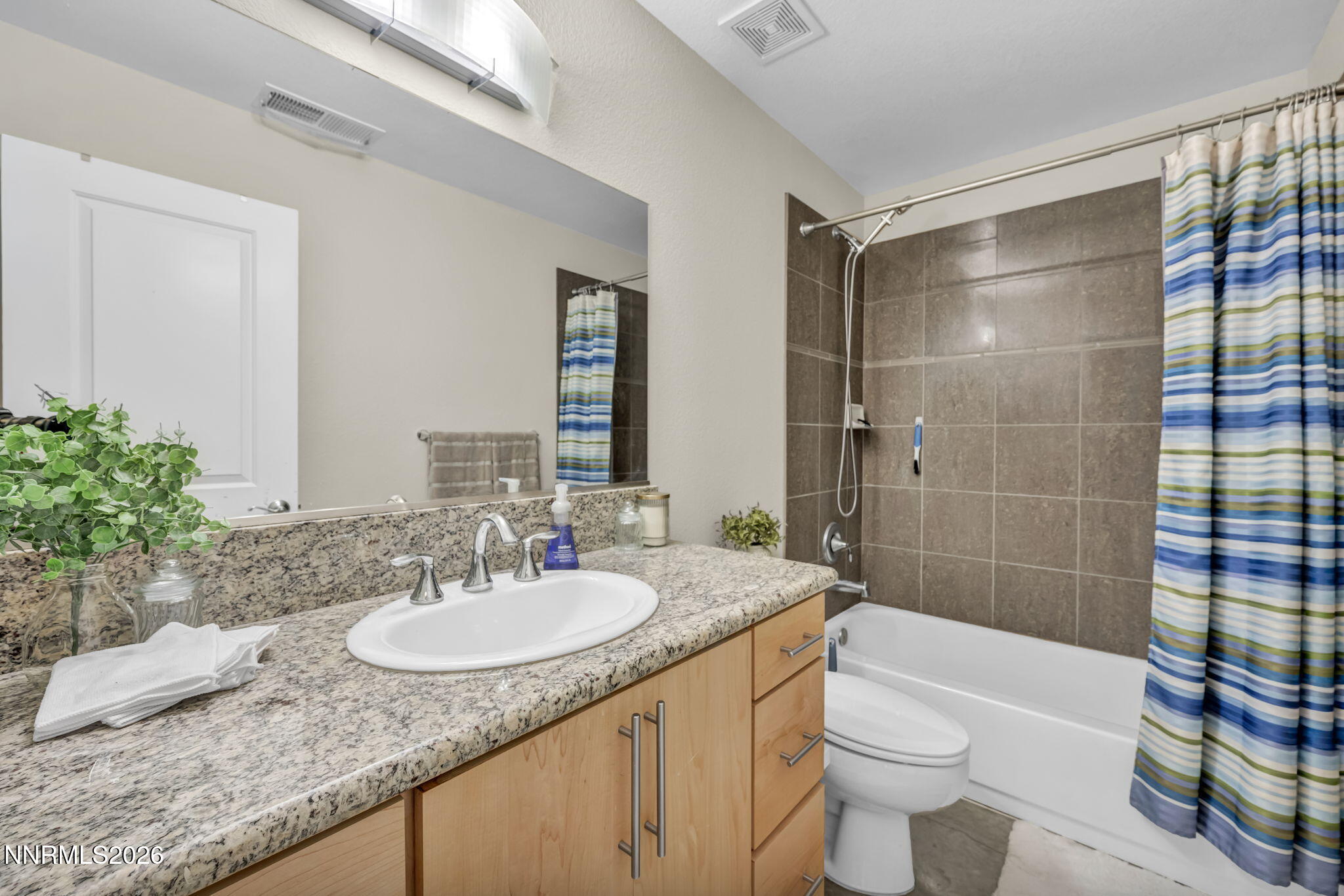 326 State Street Reno, NV 89501 - Photo 11 of 49 a bathroom with a granite countertop sink toilet mirror and shower
