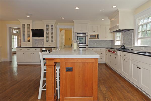 25 Irving Street Hingham, MA 02043 - Photo 7 of 30 a large kitchen with stainless steel appliances granite countertop a stove a sink a microwave and a refrigerator