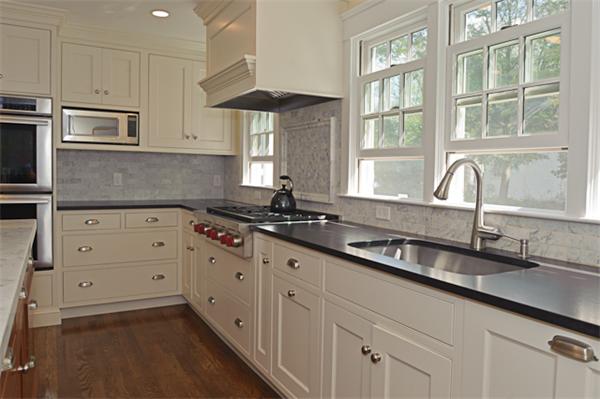 25 Irving Street Hingham, MA 02043 - Photo 8 of 30 a kitchen with granite countertop white cabinets and a window