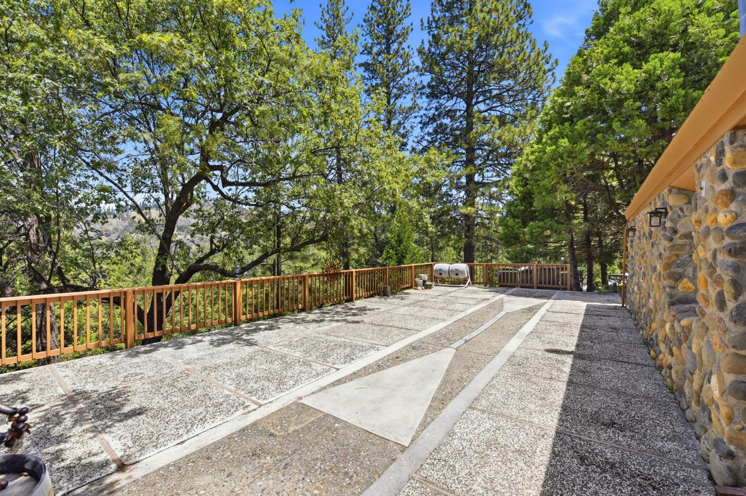 7201 Happy Valley Road Somerset, CA 95684 - Photo 57 of 75 The large concrete patio is located just outside the guest cottage and makes a grand location for a wedding reception or just a spot to have a large get together.