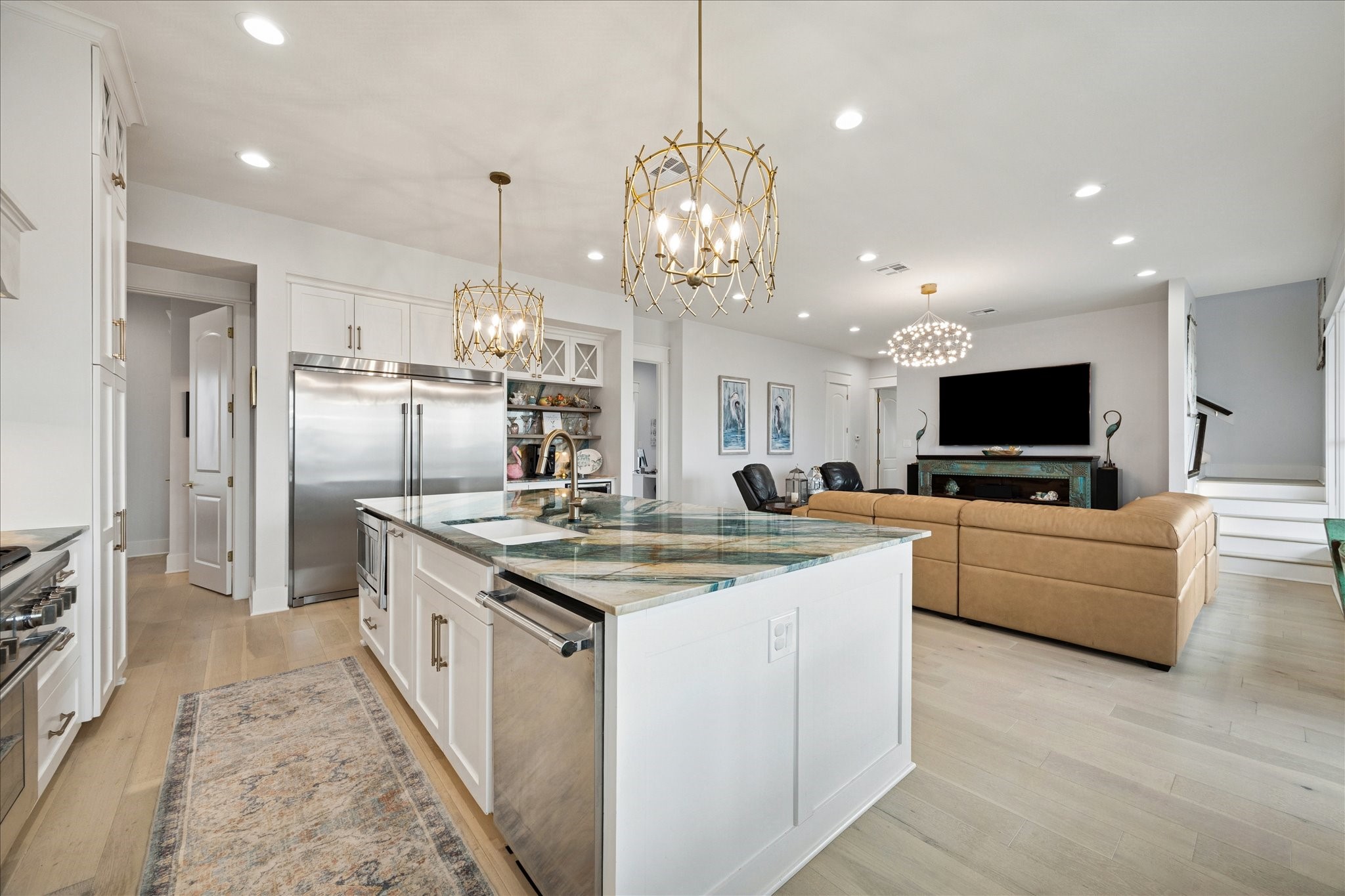 5 Loggerhead Hitchcock, TX 77563 - Photo 14 of 50 a kitchen with stainless steel appliances granite countertop a sink dishwasher a refrigerator and a dining table with wooden floor