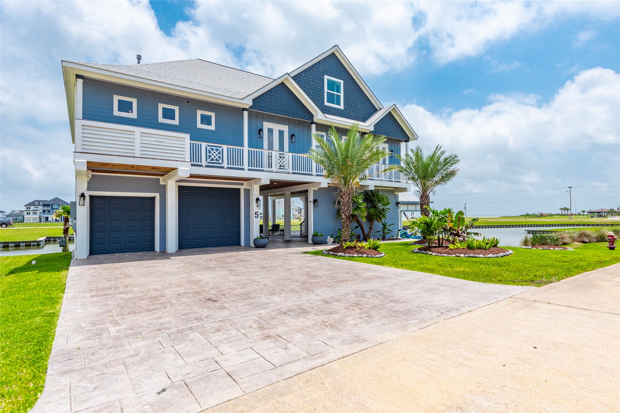 5 Loggerhead Hitchcock, TX 77563 - Photo 2 of 50 a front view of a house with a yard and garage