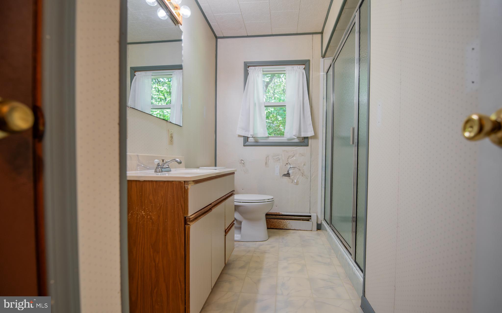 428 Hubler Ridge Road Howard, PA 16841 - Photo 12 of 19 a bathroom with a toilet sink and mirror