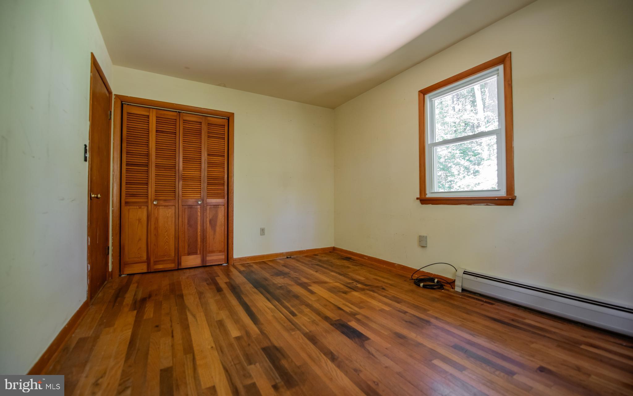 428 Hubler Ridge Road Howard, PA 16841 - Photo 17 of 19 a view of an empty room with wooden floor and a window