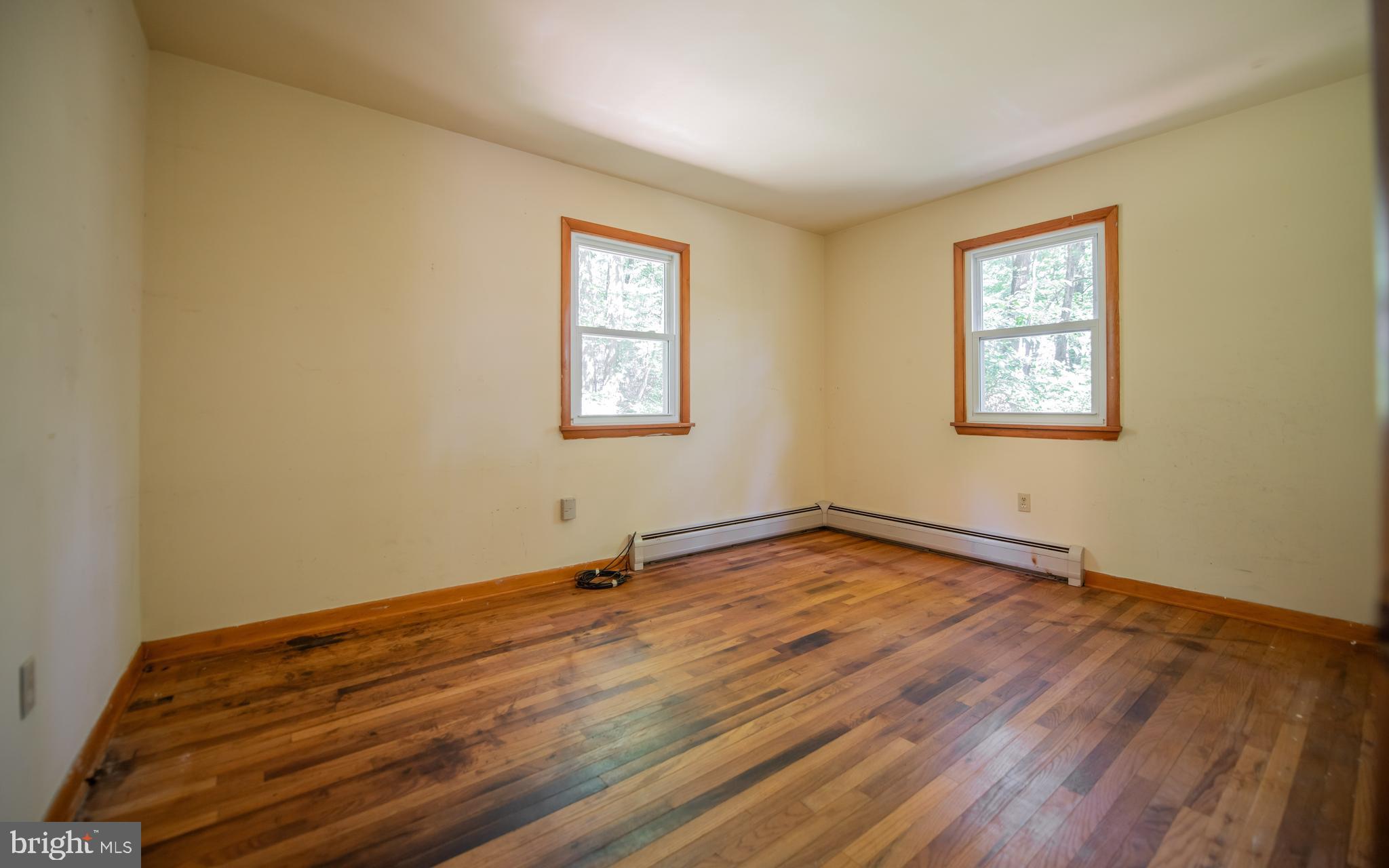 428 Hubler Ridge Road Howard, PA 16841 - Photo 18 of 19 a view of an empty room with a window and wooden floor