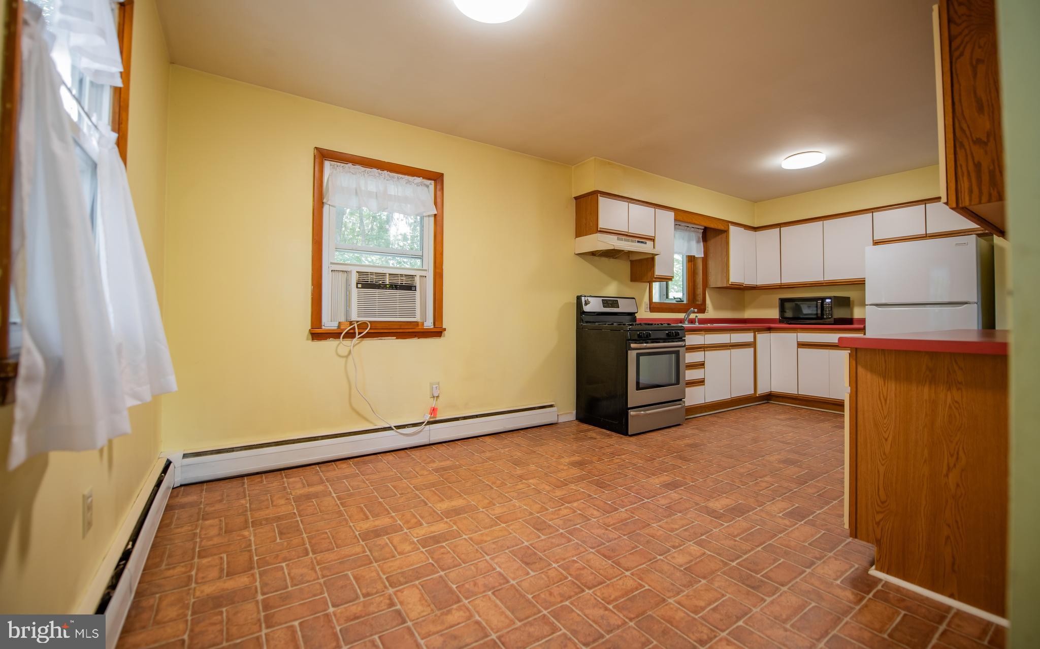 428 Hubler Ridge Road Howard, PA 16841 - Photo 5 of 19 a kitchen with stainless steel appliances granite countertop a refrigerator and a stove top oven