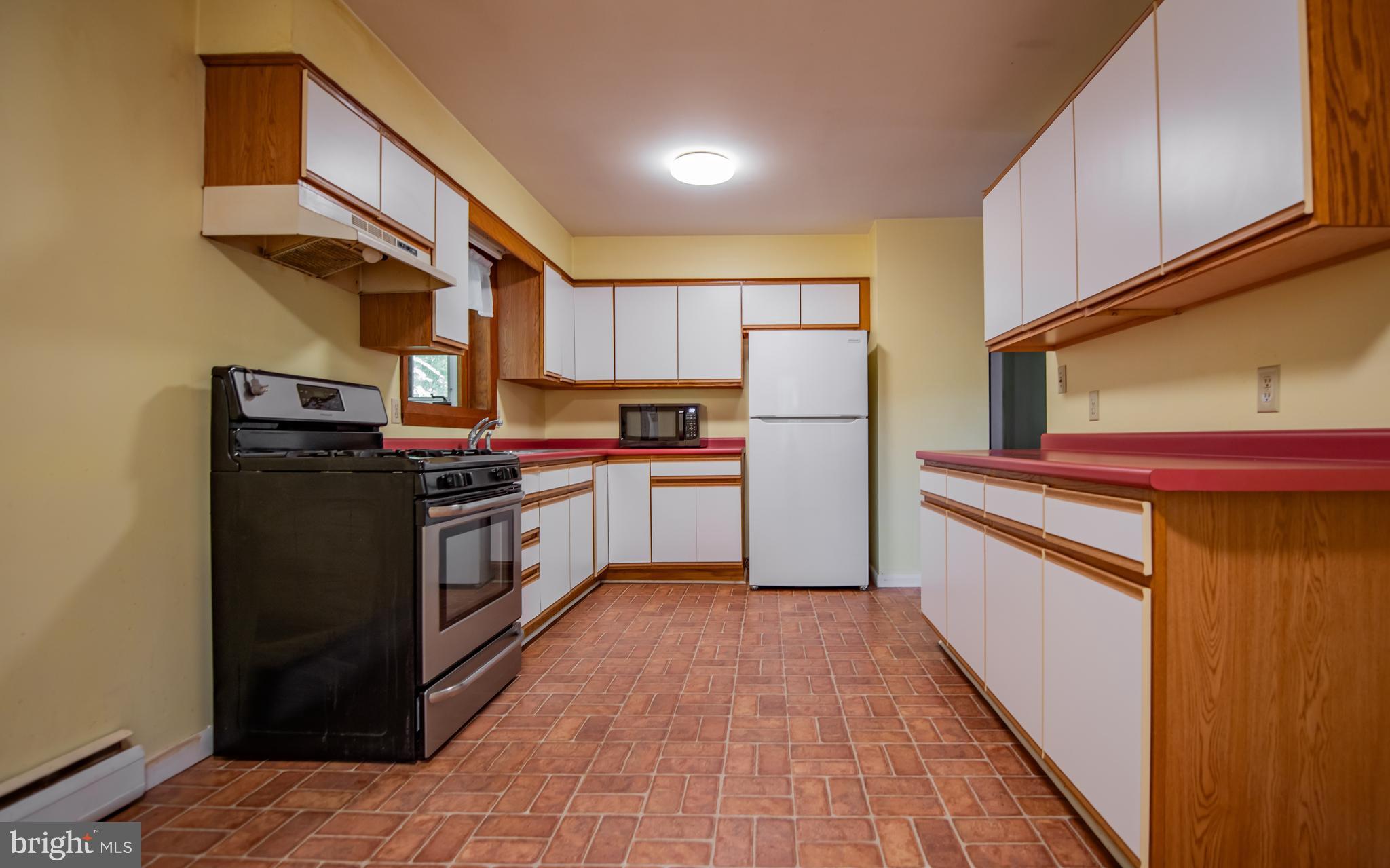428 Hubler Ridge Road Howard, PA 16841 - Photo 6 of 19 a kitchen with stainless steel appliances a refrigerator and a stove