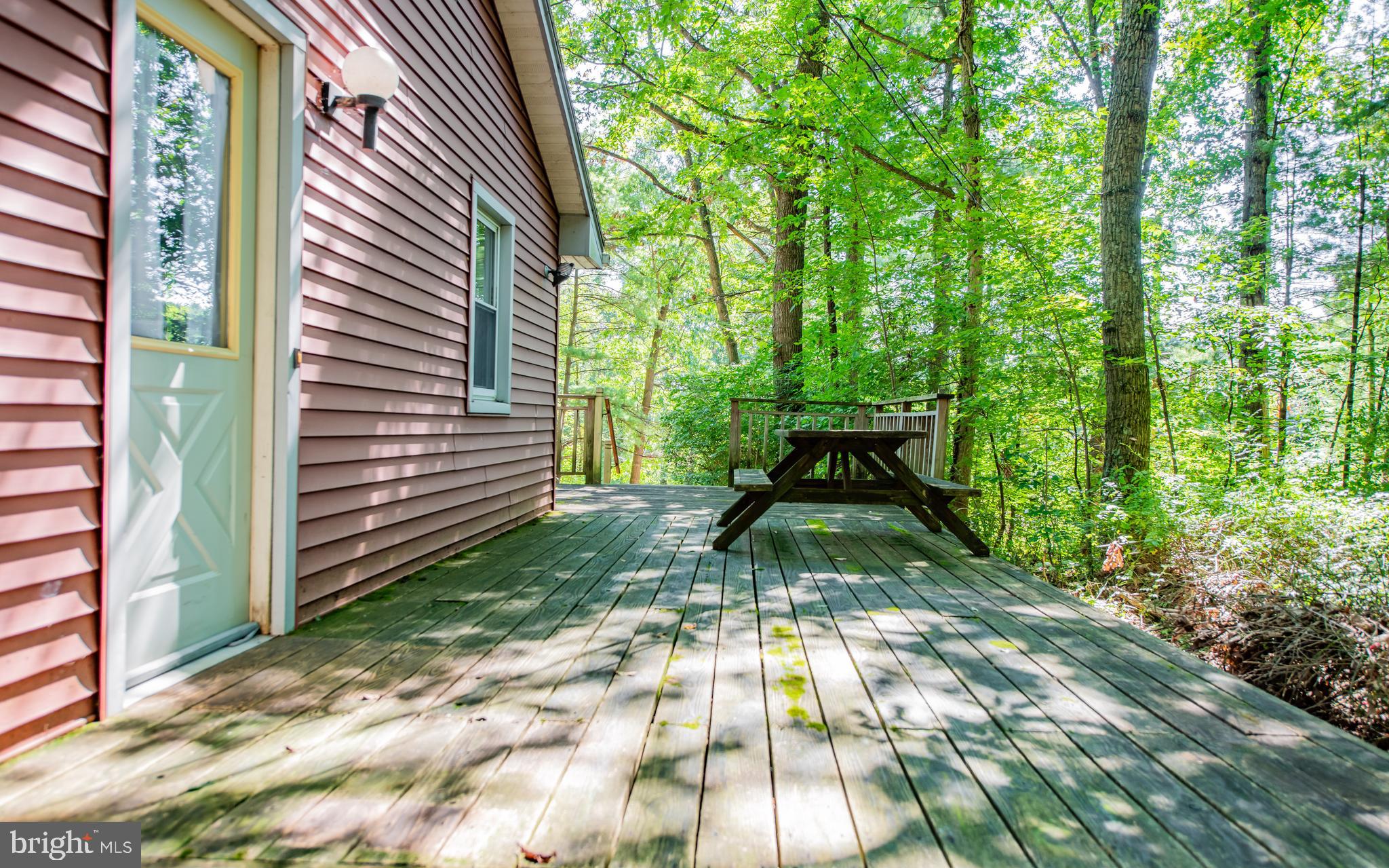 428 Hubler Ridge Road Howard, PA 16841 - Photo 7 of 19 a view of backyard with table and chairs and potted plants