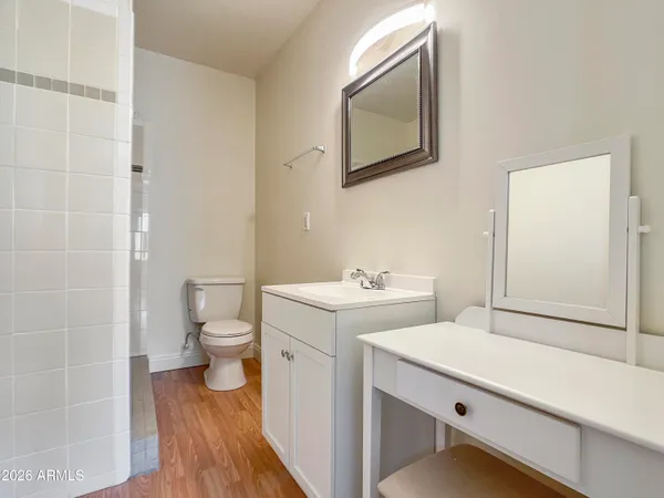 a bathroom with a toilet sink and mirror