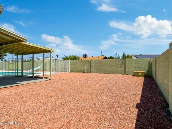 a view of a house with a yard and a garage