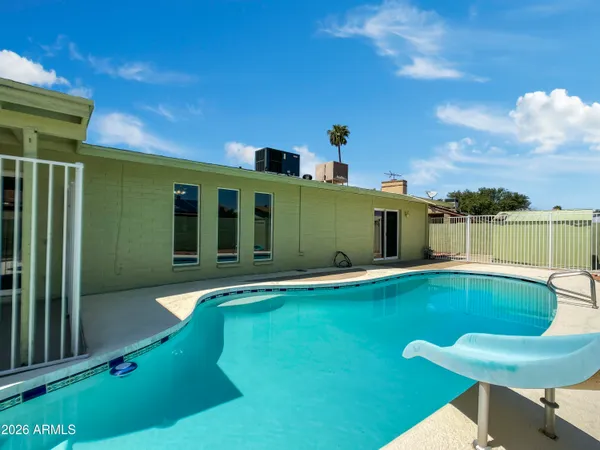 a view of a swimming pool with a patio
