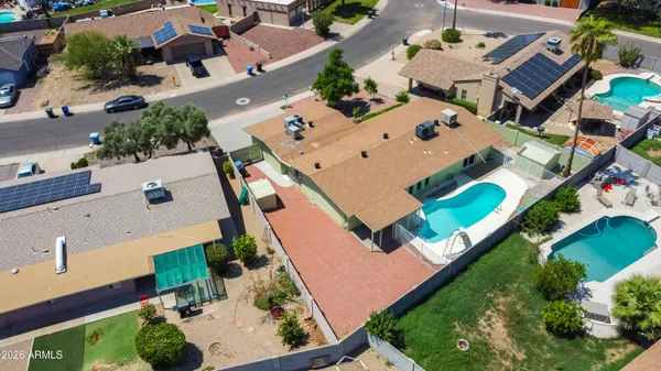 an aerial view of a house with a yard