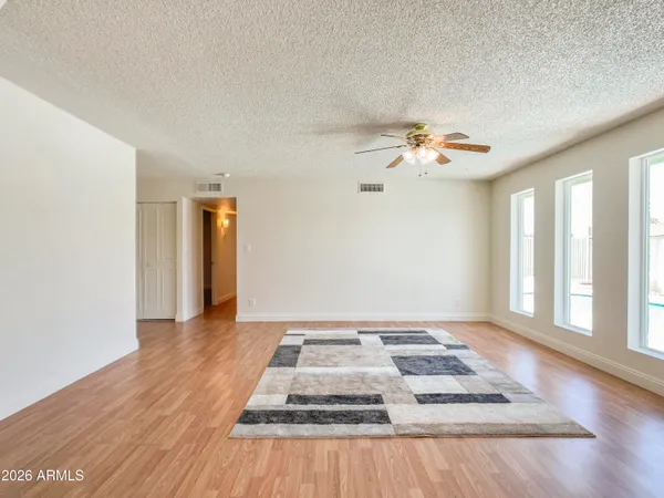 a view of a livingroom with a ceiling fan and window