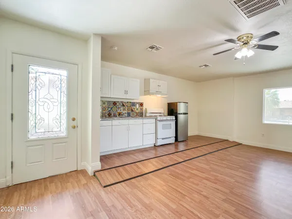 a view of kitchen with cabinets and wooden floor