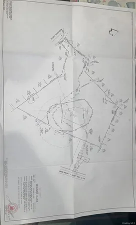 a picture of a room with a white walls and a painting on the wall