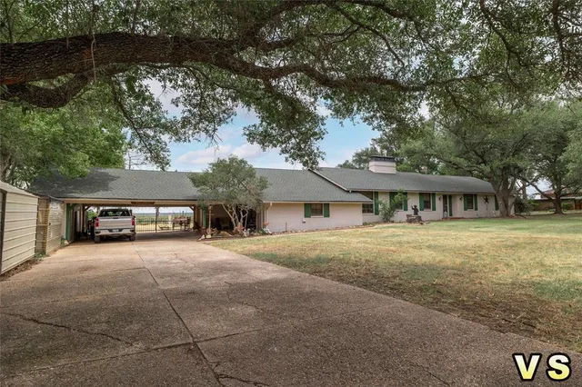 a big house with a big yard and large trees