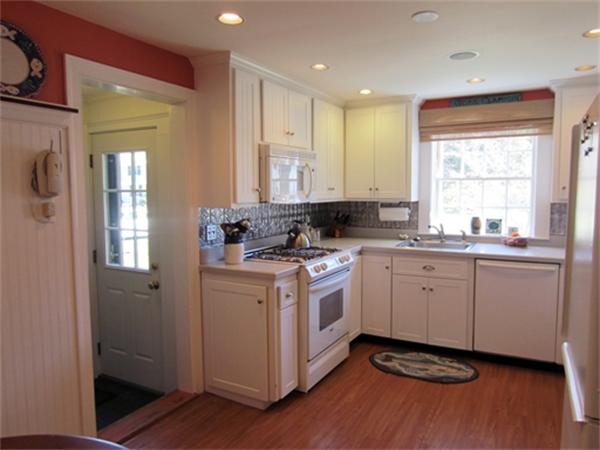 19 Southgate Road Wellesley, MA 02482 - Photo 4 of 14 a kitchen with granite countertop white cabinets and white appliances