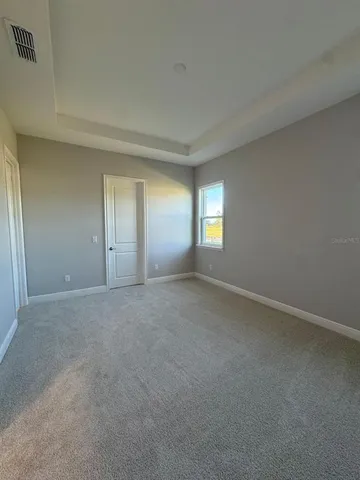 a view of an empty room with windows