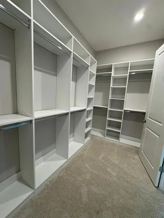a view of an empty room with empty shelves