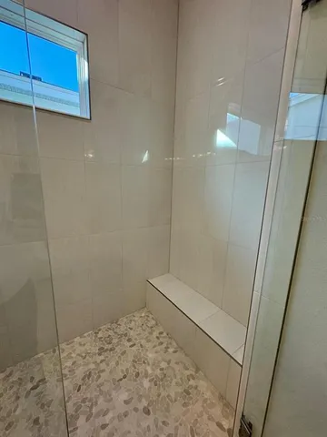 an empty room with wooden floor and a window