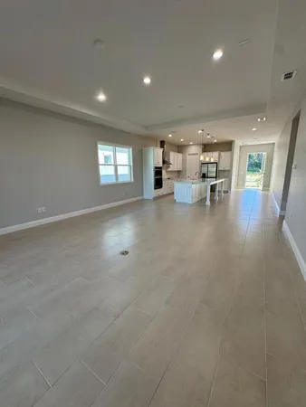 an open kitchen with kitchen island a sink a stove and a refrigerator