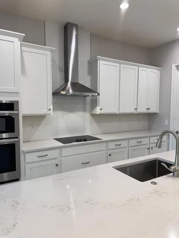 a kitchen with stainless steel appliances granite countertop a sink dishwasher stove and refrigerator