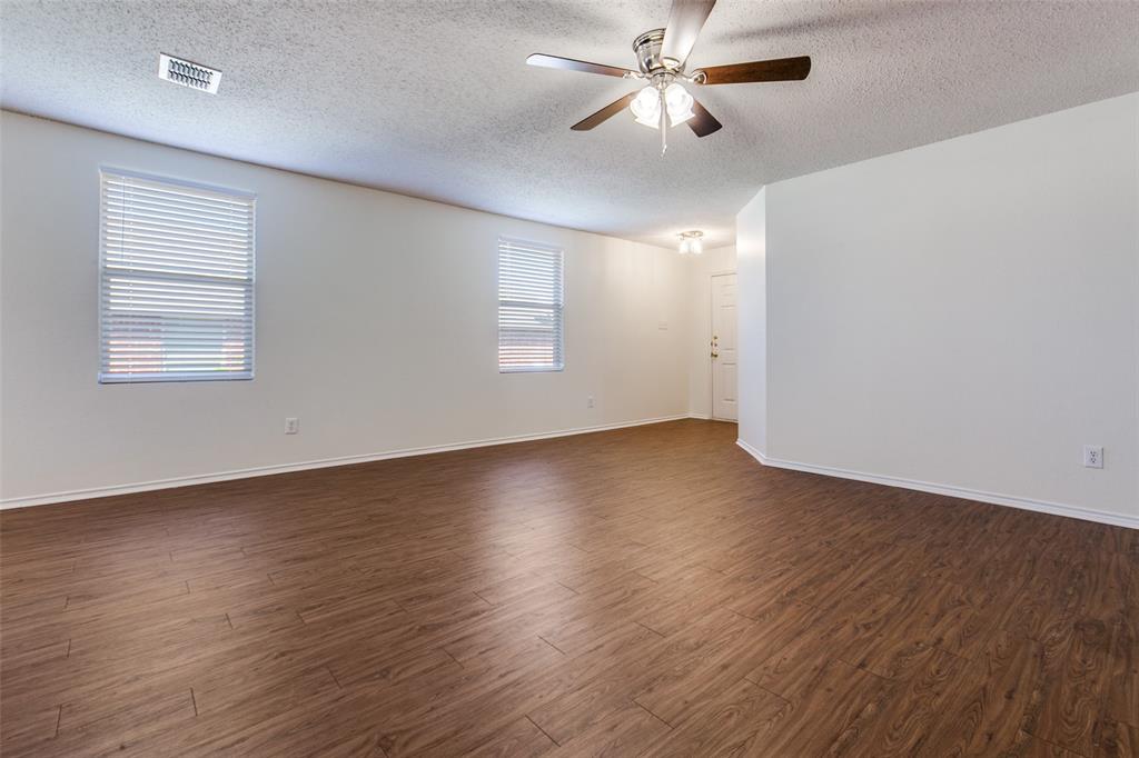 2613 Salt Maker Way Little Elm, TX 75068 - Photo 9 of 16 a view of an empty room with wooden floor and a window