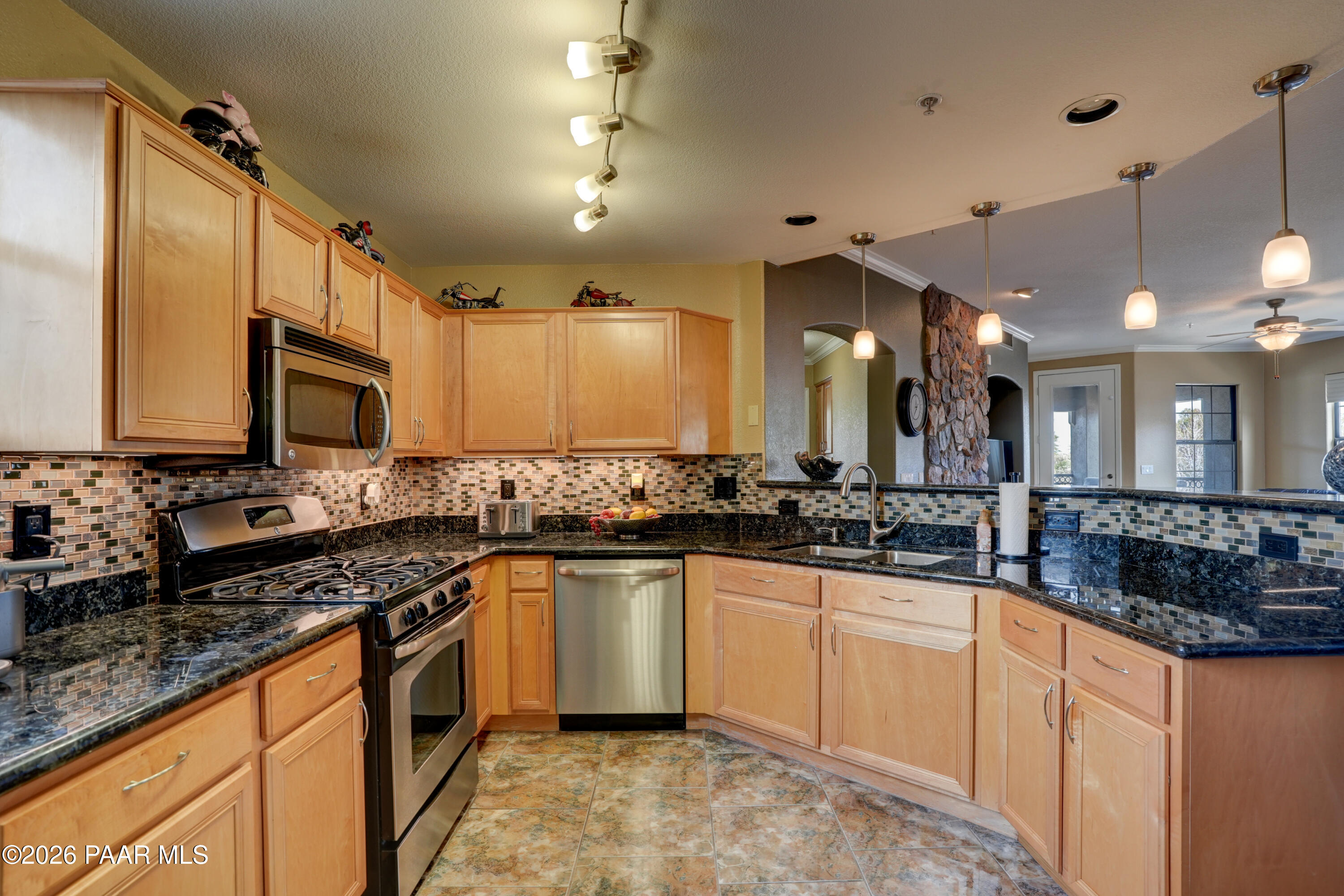 1716 Alpine Meadows Lane, Unit 405 Prescott, AZ 86303 - Photo 16 of 29 a kitchen with stainless steel appliances a sink stove and cabinets