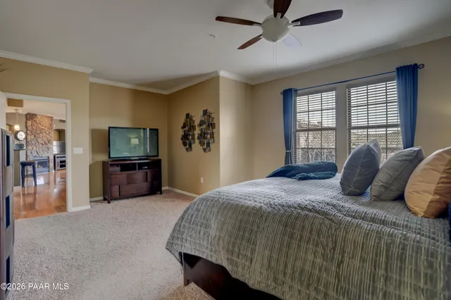 a bedroom with a bed and a tv