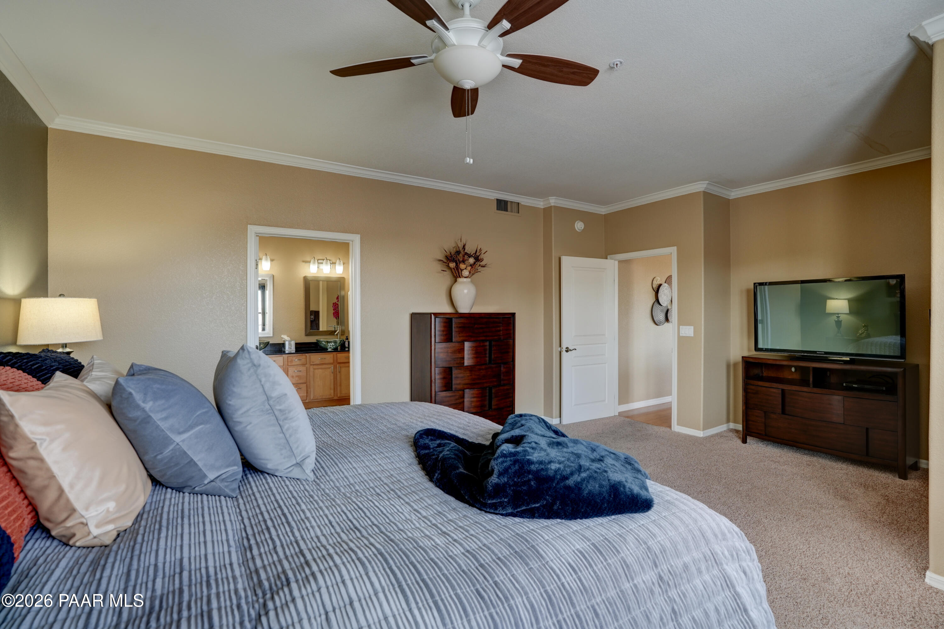 1716 Alpine Meadows Lane, Unit 405 Prescott, AZ 86303 - Photo 21 of 29 a bedroom with a bed and a flat screen tv