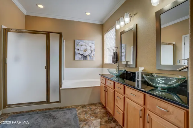 a large bathroom with double vanity and a mirror